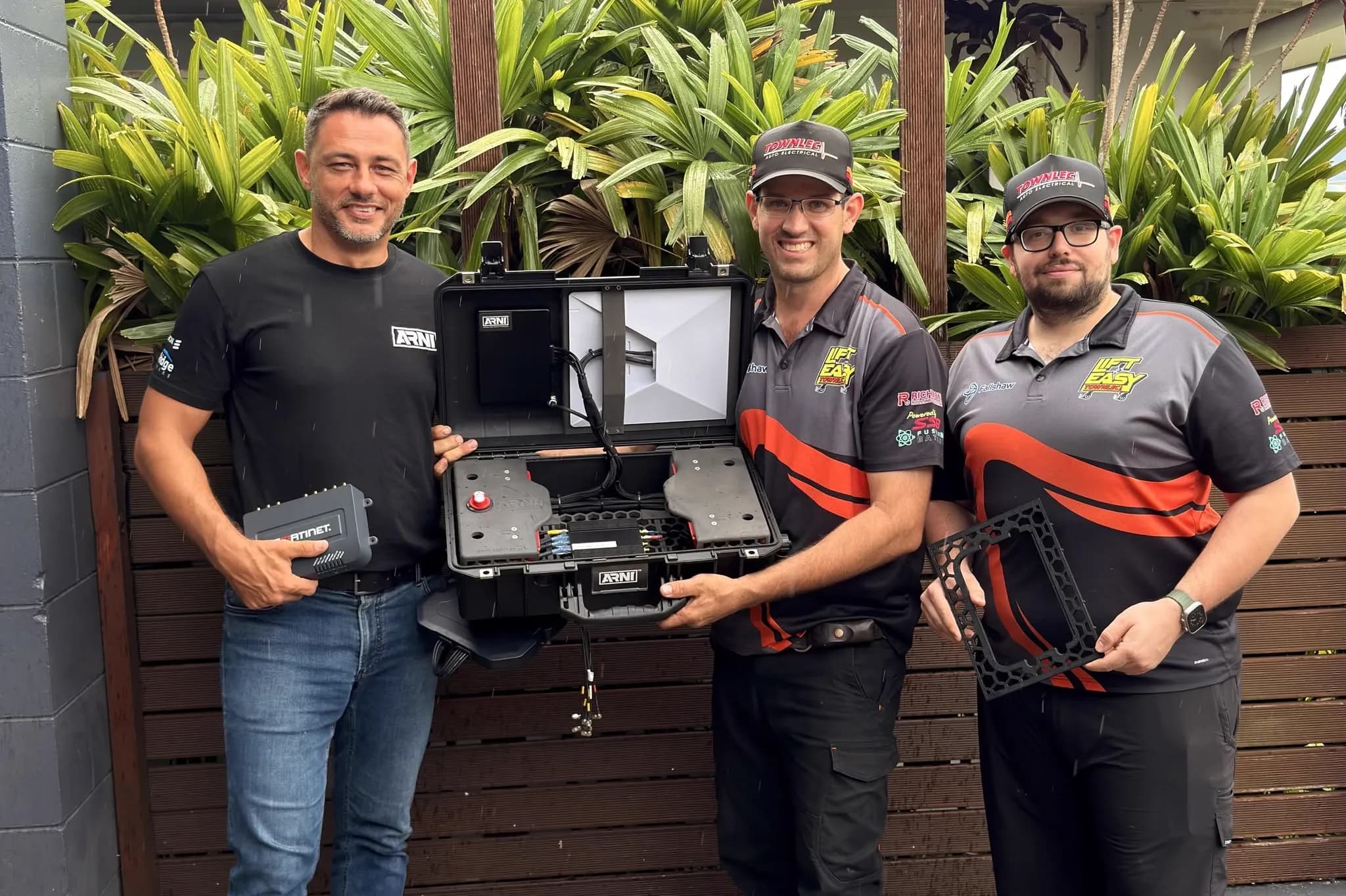 Townlec staff with AirBridge, holding an open ARNI rapid-deployment network case with 3D printed mounting trays inside and a printed lattice frame alongside