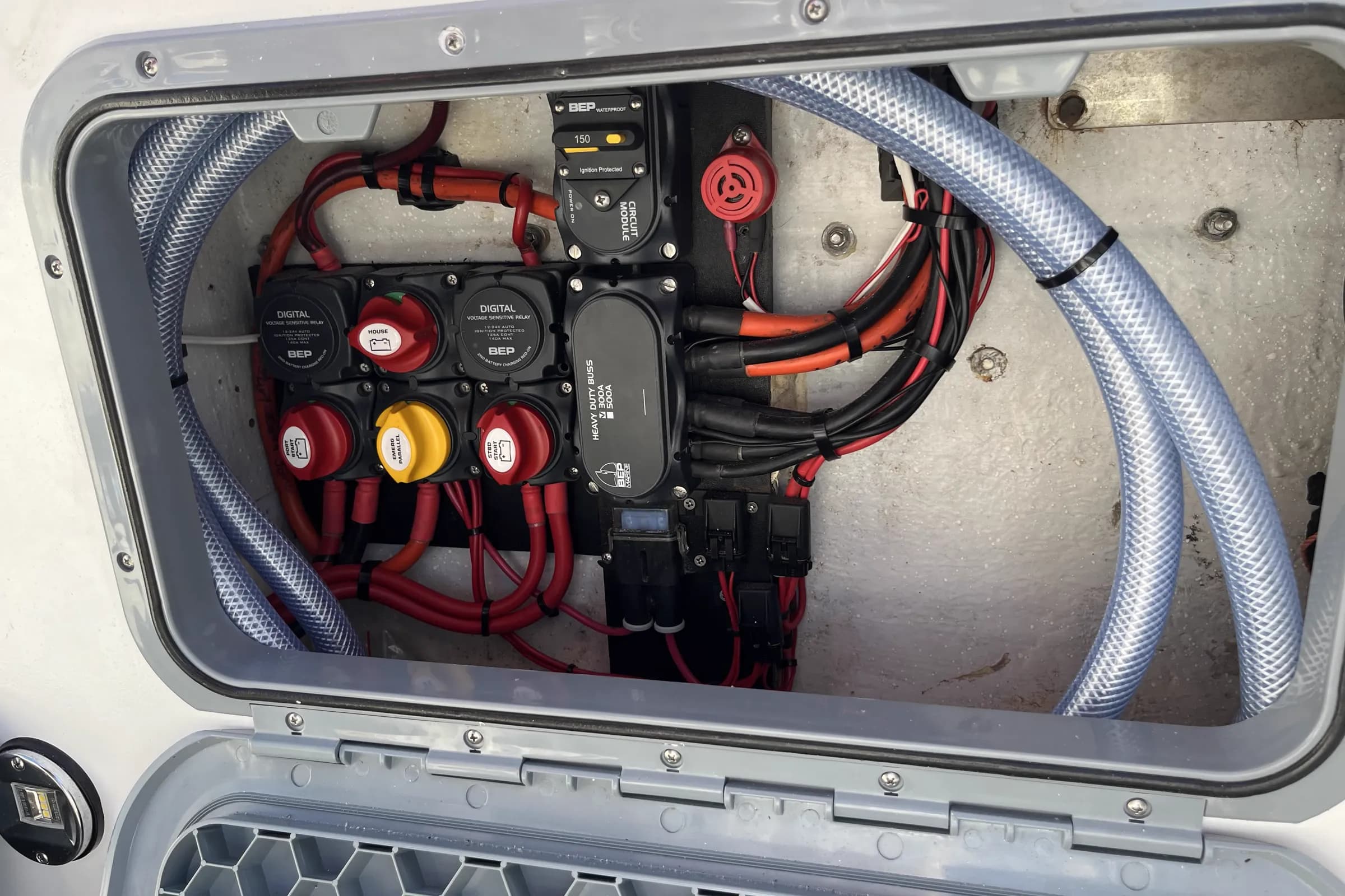 A boat battery switching panel with two BEP digital voltage sensitive relays, house, port start and starboard start isolators, an emergency parallel switch, a 150A circuit module and a heavy duty busbar
