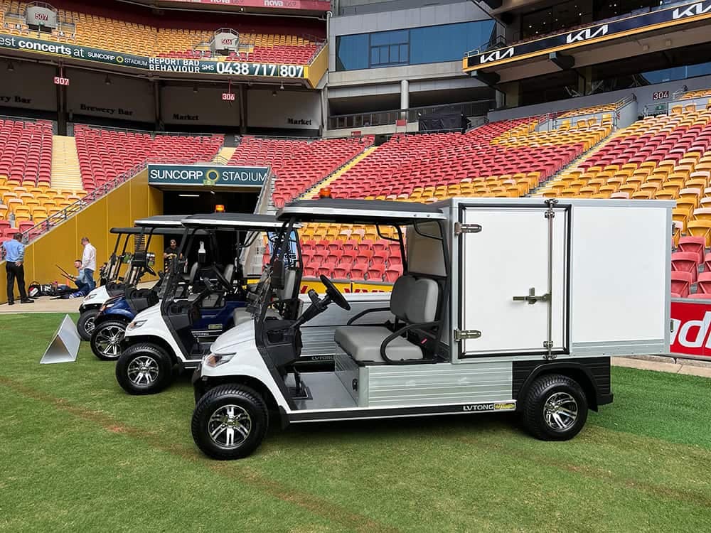 LVTong electric utility carts, one with an enclosed cargo box, lined up on the pitch at Suncorp Stadium